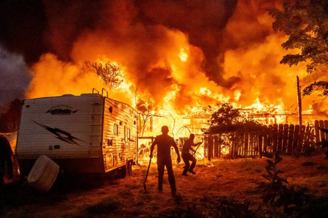 Residents try to stop flames from a burning home 